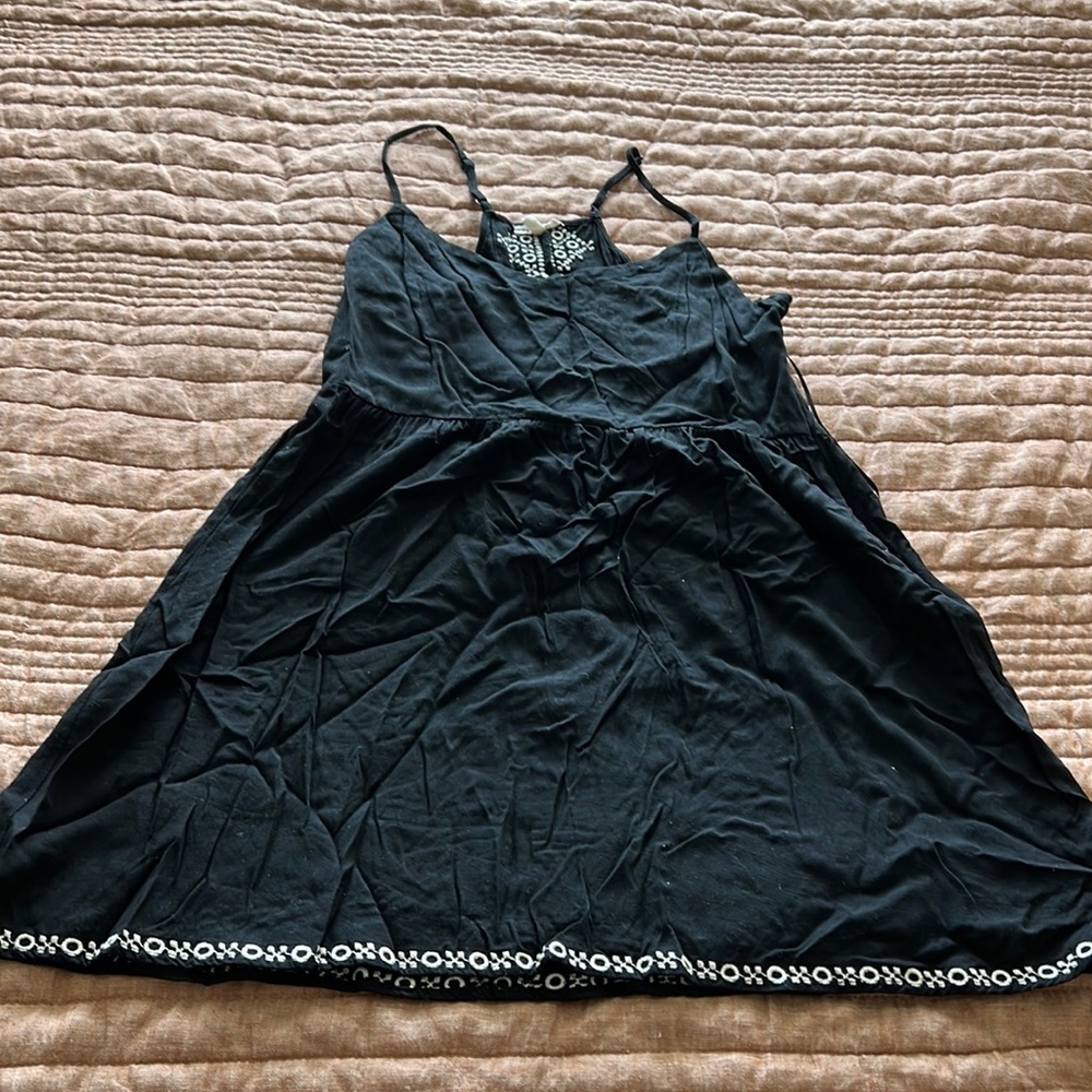 An embroidered mini racer back black dress